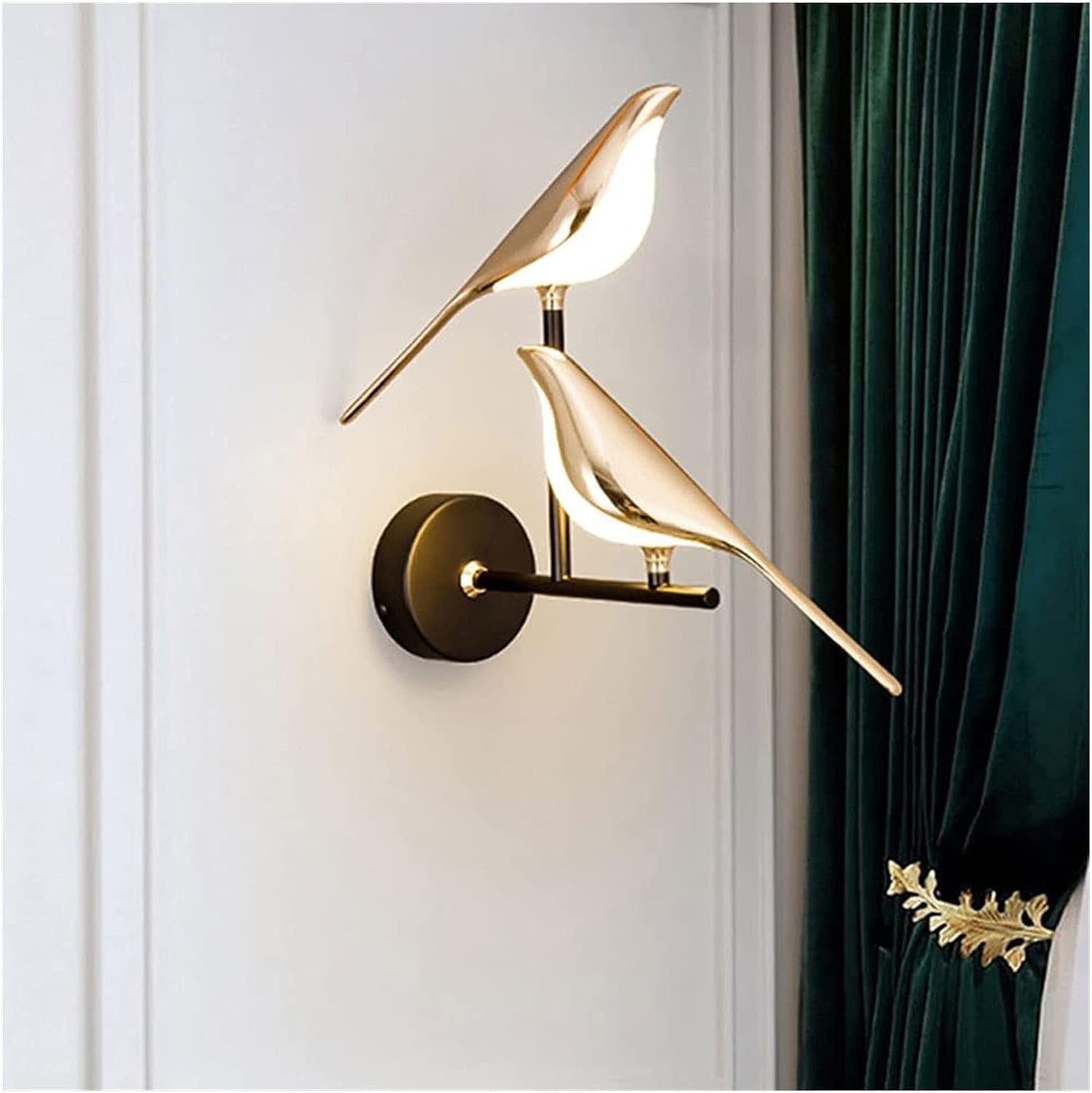 Illuminate your outdoor space with the Bird LED Wall Sconce in Gold. Enhance your exterior with stylish outdoor wall lights, sconces, and decorative elements.